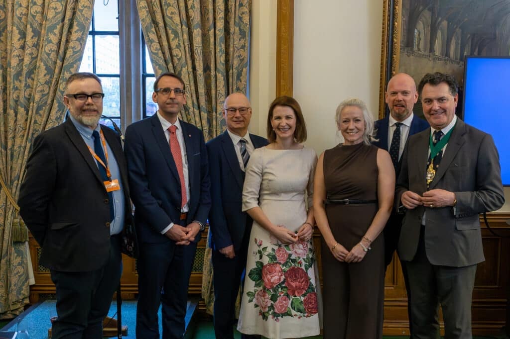 Team members from both The Honourable The Irish Society and Ulster University pose for a picture in the Churchill Room before the event starts